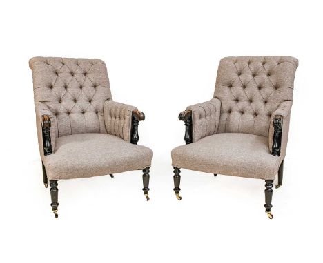 A Pair of Late Victorian Ebonised and Buttoned Library Armchairs, late 19th century, recovered in light grey fabric with over