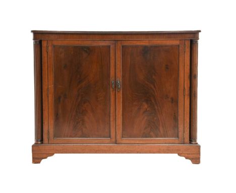 An Early 19th Century Mahogany Double-Door Cupboard, with reeded edge above a plain frieze, the moulded cupboard doors enclos