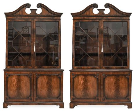 A Pair of Reproduction Mahogany Bookcases, in George III style, with swan neck pediments above dentil moulding and astragal g