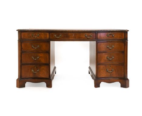 A 20th Century Mahogany and Oak-Lined Partners' Desk, in George III style, of serpentine-shaped form with brown leather writi