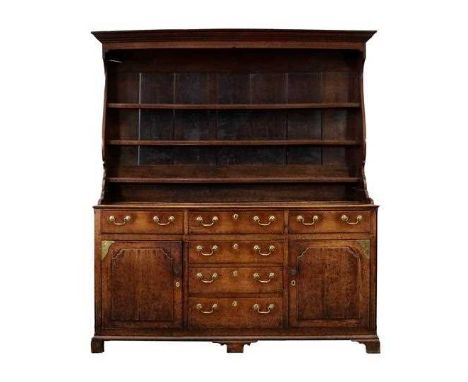 A George III Oak Enclosed Dresser and Rack, late 18th century, the upper section with bold cornice above three fixed shelves 