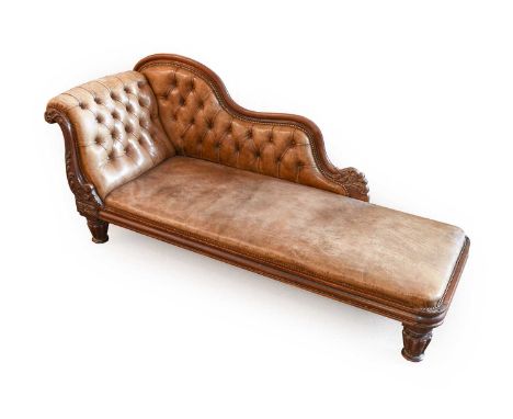 A William IV Carved Mahogany Chaise Longue, circa 1830, covered in light-tan buttoned and close-nailed leather with moulded a