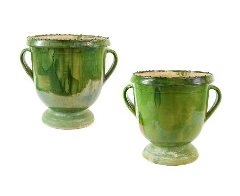 A Pair of Green Glazed Terracotta Urns, of ovoid form with strap handles and circular feet,internal diameter 36cmheight 39cmP