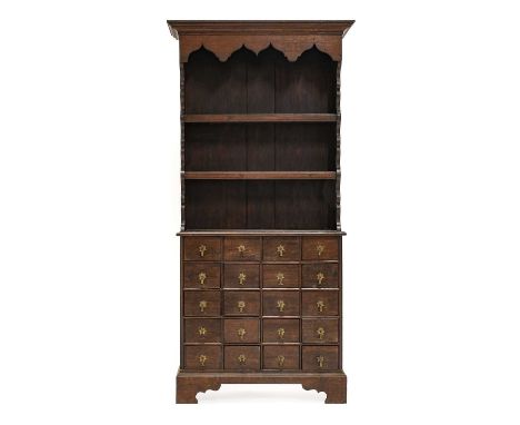 An Oak Dresser, of attractive proportions, the moulded cornice above an arched apron and two fixed shelves, the base with twe