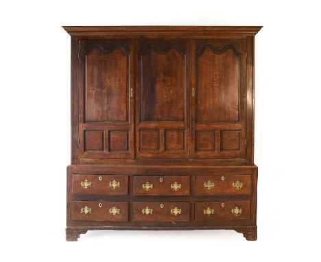 A George III Joined Oak Housekeeper's Cupboard, the moulded cornice above two fielded cupboard doors enclosing a later pine-l