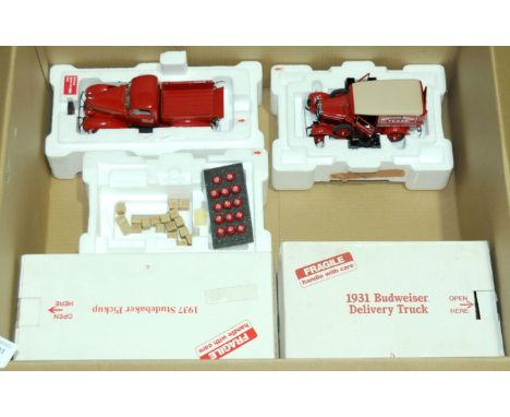 Danbury Mint. A boxed pair of 1:24 scale Truck models comprising off 1937 Studebaker Pickup Truck in Red along with a 1931 Bu