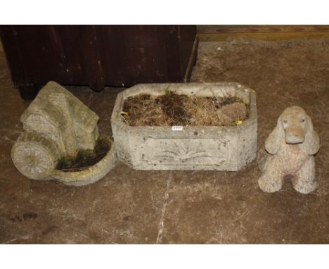 AN OCTAGONAL STONE PLANTER TOGETHER WTIH TWO STONE GARDEN FIGURES