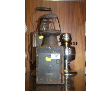 AN OIL BURNING LAMP AND TWO LANTERNS