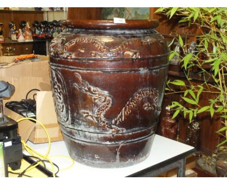 A LARGE TREACLE GLAZE TYPE PLANTER WITH ORIENTAL DRAGON DETAIL