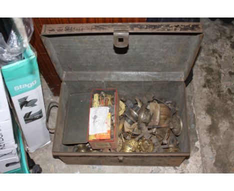 A TIN TRUNK CONTAINING OIL LAMP BURNERS ETC