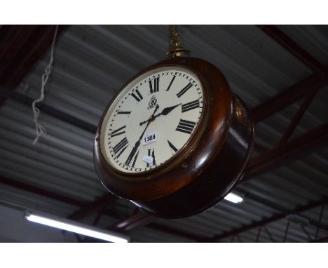 A GEORGE V MAHOGANY CIRCULAR DOUBLE SIDED HANGING PLATFORM CLOCK, fitted with an electric movement, approximate size diameter