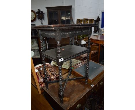 AN EARLY 20TH CENTURY OAK FOLD OVER CARD TABLE, on turned uprights