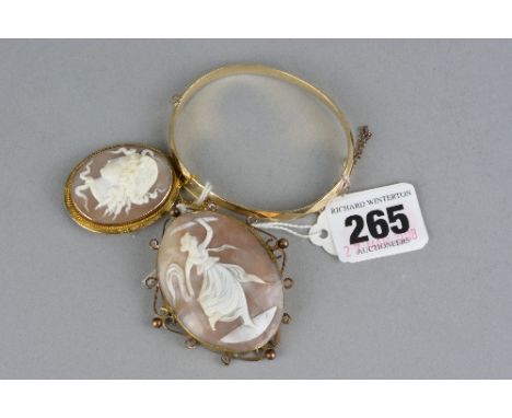 A 9CT AND ROLLED GOLD BANGLE, together with two yellow metal cameos (3)