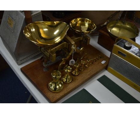 A SET OF C.STEVENS LONDON BRASS SCALES, mounted on wooden base with a set of weights from 2lb to 1/2oz