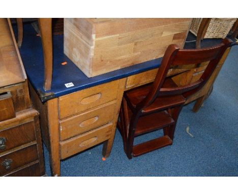 A MID CENTURY OAK KNEEHOLE DESK, and a reproduction metamorphic library step chair