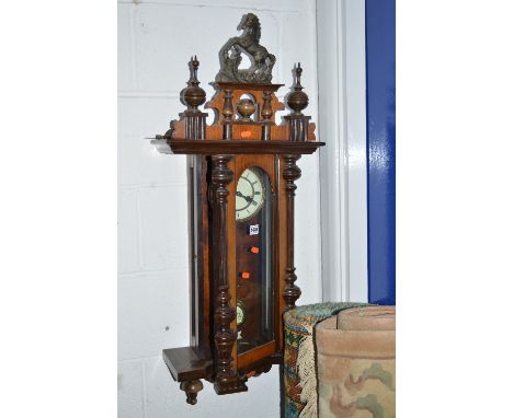 A VIENNA WALL CLOCK, with a horse pediment (winding key)