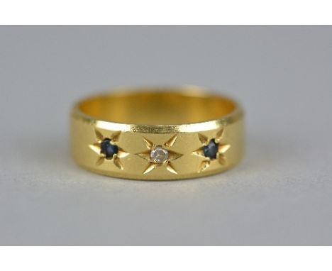 A LATE 20TH CENTURY 18CT GOLD SAPPHIRE AND DIAMOND THREE STONE GYPSY SET BAND RING, diamond weight approximately 0.01ct, ring