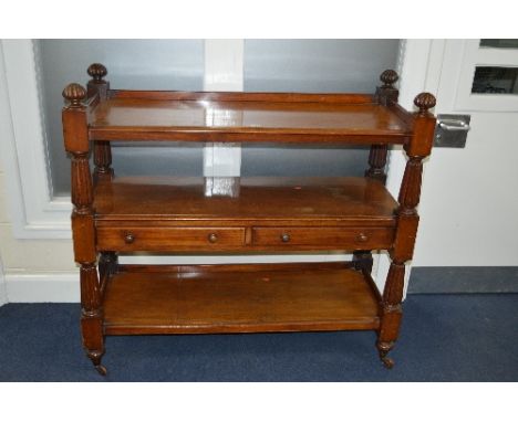 A VICTORIAN MAHOGANY THREE TIER BUFFET, the central shelf with two long drawers, on ceramic casters, approximate size width 1