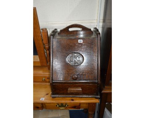 AN EARLY 20TH CENTURY OAK LOG BOX, with hinged fall front with the initials C K carved to the door and a single drawer