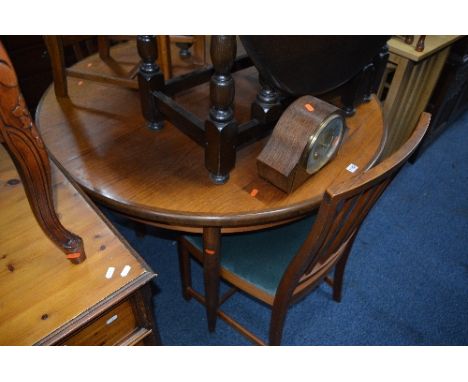 A ROUND TEAK TABLE, and four teak chairs (stamped Apr 1972) and an oak mantel clock (6)