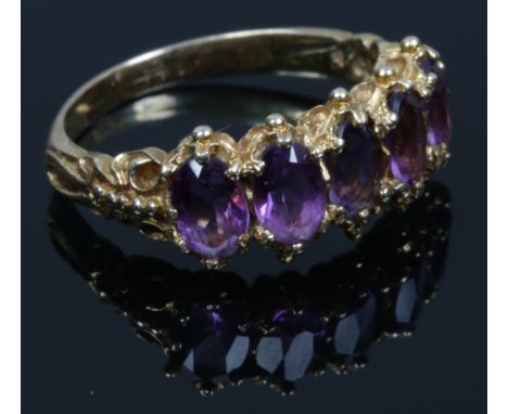 A 9ct gold five stone amethyst ring set with ovoid cut stones. Size P.