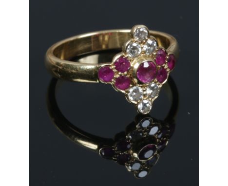 An 18ct gold ruby and diamond cluster ring. Size N 1/2.