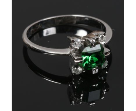 An 18ct white gold and four stone diamond ring with green coloured paste centre stone acid test as gold, size M.