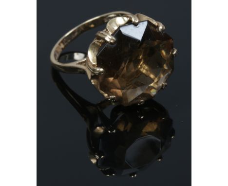 A 9ct gold cocktail ring set with a large smoky quartz stone, size L.