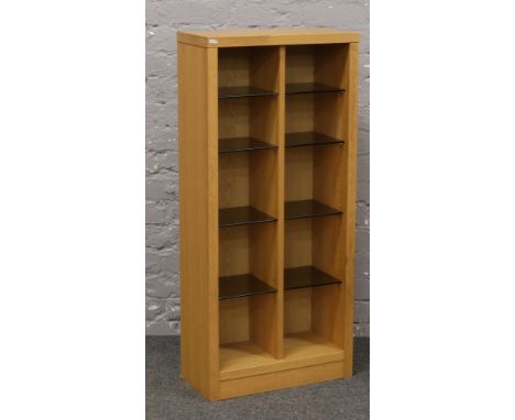 A modern light oak shelving unit with smoked glass shelves.