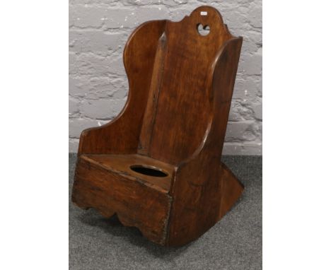A 19th century childs ash and oak rocking chair commode.