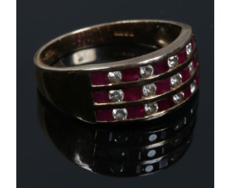 A 9ct gold ruby and diamond three row channel set ring. Size M.