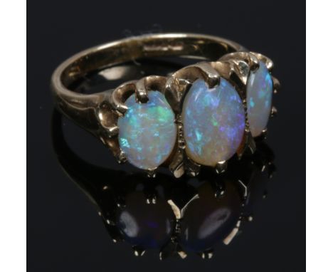 A 9ct gold three stone opal ring in claw settings. Size I 1/2.