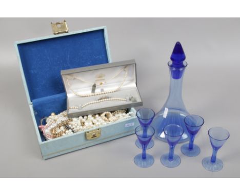 A jewellery box and assorted simulated pearls including a cased suite of Mikazuki pearls and a blue glass decanter set.