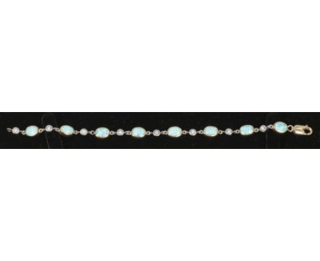 A 9ct gold bracelet set with diamonds interspersed with opal coloured stones, 10.7 grams.&nbsp;