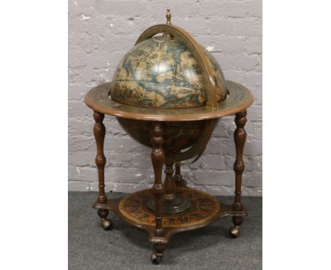 A globe cocktail cabinet on castered stand.