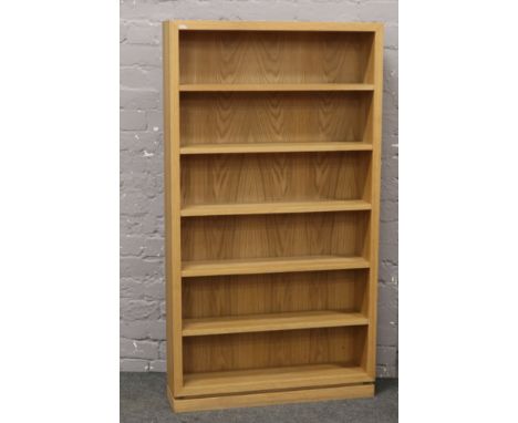A modern light oak bookcase, 144 x 79 x 19cm.
