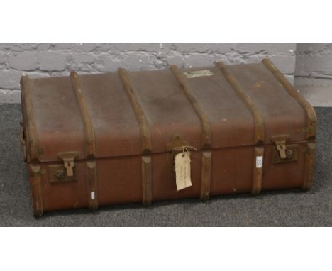 A vintage wood bound steamer trunk, RAF spitfire connection with a partial label to the base.