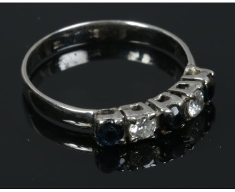 A platinum ring set with diamonds and sapphires, size M1/2.