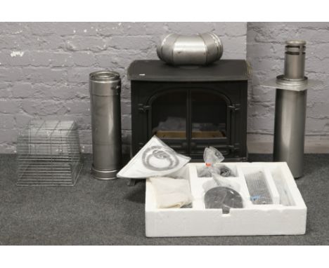 A cast iron Clarendon &amp; Ashdon gas stove with stainless steel flu and installation manual.