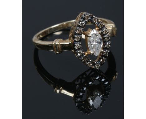 A 9ct gold and diamond ring. With a marquis cut principle stone under a navette border of cognac diamonds. Size Q 1/2.