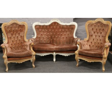 A French carved walnut two seat sofa upholstered in pink along with two matching armchairs for re-upholstery.