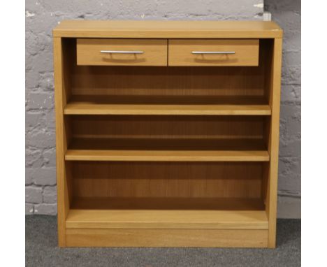 A modern light oak shelving unit with two drawers.