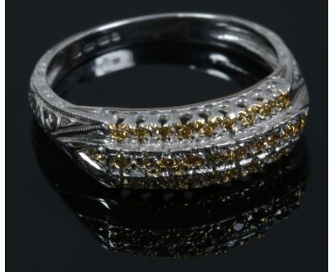 A 14ct white gold ring set with three rows of champagne diamonds, size O.