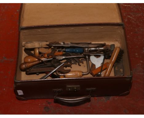 A vintage suitcase to include a collection of hand tools.