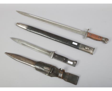 A German World War II bayonet with scabbard and leather frog, makers mark for P Weyersberg, along with a British sword bayone