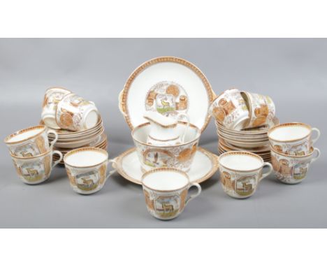 A 19th century Aesthetic movement 12 place porcelain tea service c.1870-90 printed and enameled with stags and landscape scen