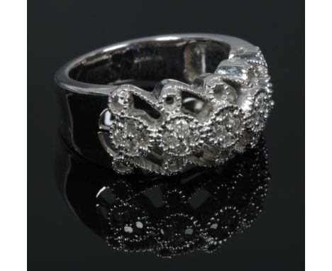 A 9ct white gold and diamond ring with openwork milgrain shank, total diamond weight 0.35ct with certificate, size O.