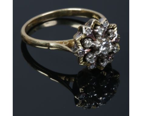 An 18ct gold and diamond snowflake cluster ring with chased border, 6.8 grams. Size R.