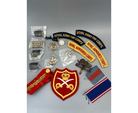 A diverse selection of British military items, including a Royal Victorian Order medal ribbon, a British Army Physical Traini