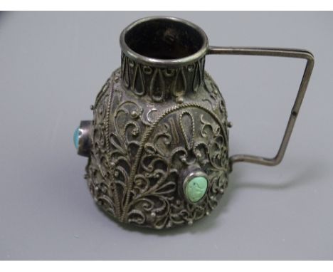 CONTINENTAL FILIGREE OVERLAY &amp; TURQUOISE MOUNTED WHITE METAL JUG, 5.5cms H, makers stamp to the handle contained in a non